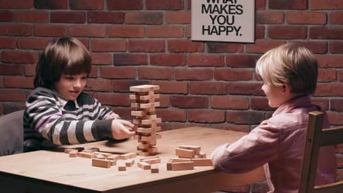 Children Playing Tower Building Game Together