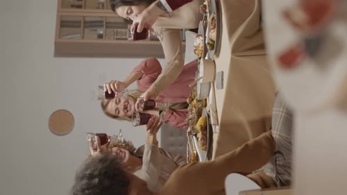 Adult Friends Raise Wine Glasses for Dinner Party Toast