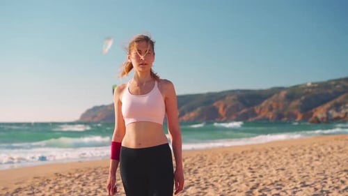 Athletic Woman Stands on Sunny Beach