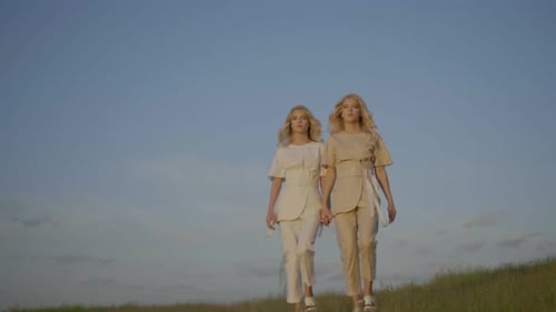 Twins Sisters Are Having a Walk