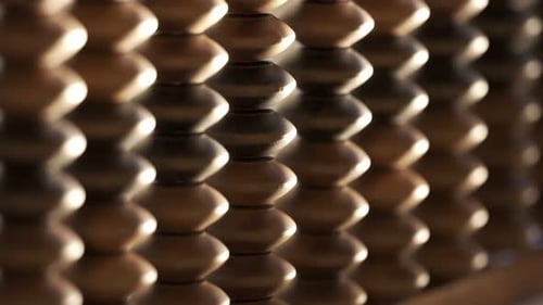 Organic Wooden Beads Rotating in Abstract Rhythmic Pattern