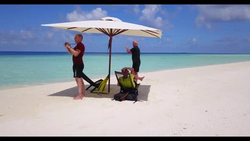 Man and lady sunbathe on relaxing island beach break by blue ocean and white sandy background of the