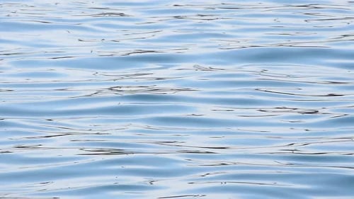 Background of blue sea waves and ripples on water surface