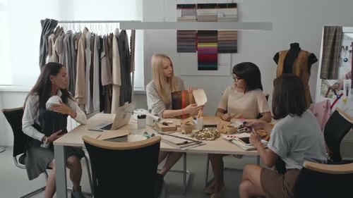 Young Women Brainstorming Fashion Designs in Workplace