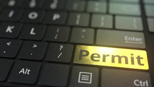 Black Computer Keyboard and Gold Permit Key