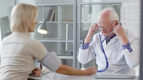 Doctor Checks Patient's Blood Pressure in Office