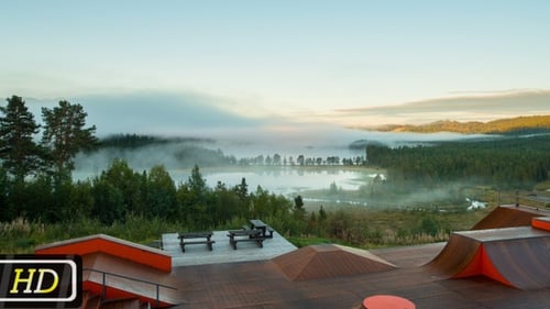 Skatepark Overlooking Hazy Lake and Forest Landscape