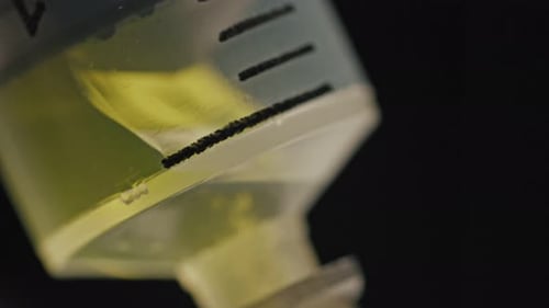 Extreme Close-up of Syringe Being Filled with Yellow liquid.Concept of Coronavirus Vaccination