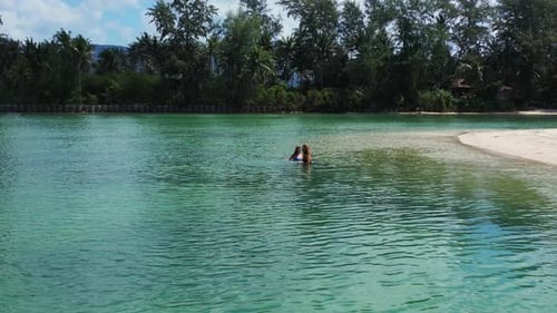 Sexy beauty models on holiday having fun at the beach on clean white sand and blue