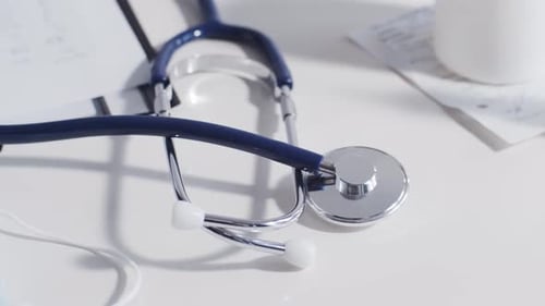 Close-up of different stuff and equipment on doctor's table in medical office in hospital.