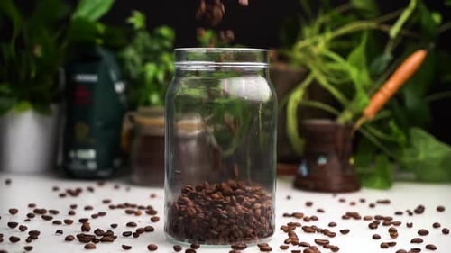 Coffee Beans Falling into Jar in Kitchen Setting