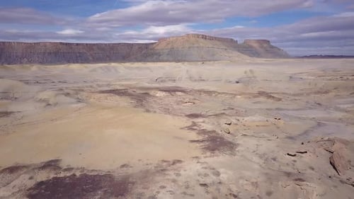 Flying backwards over desert terrain