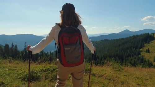 Traveler Enjoys the Landscape on the Top of the Mountain