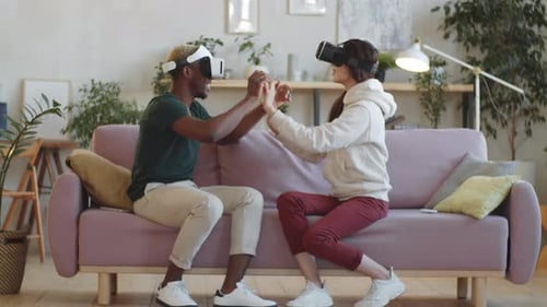 Couple Enjoys Virtual Reality Headsets on Couch