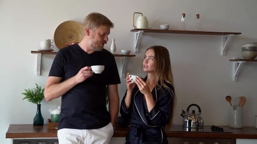 Happy Couple Enjoying Morning Coffee in Bright Kitchen