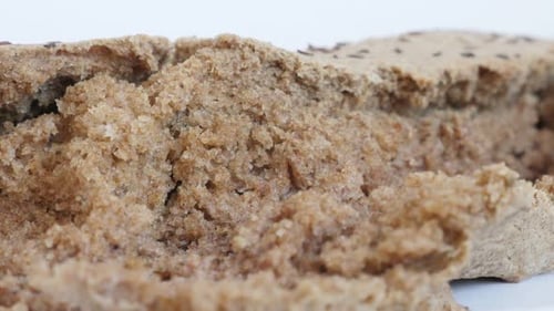 Rustic bread brown crust made from full healthy grain and barley 4K 2160p 30fps UltraHD panning foot