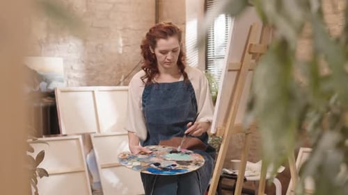 Young Woman Painting in Studio