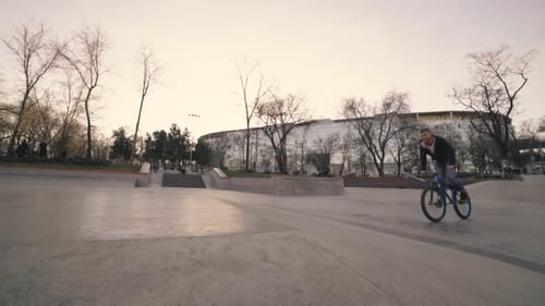 MTB Bicycle Rider Does Various Tricks While Riding in Skatepark