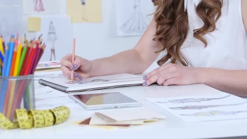 Artist Sits in Her Study, Sketches a New Collection. Close Up