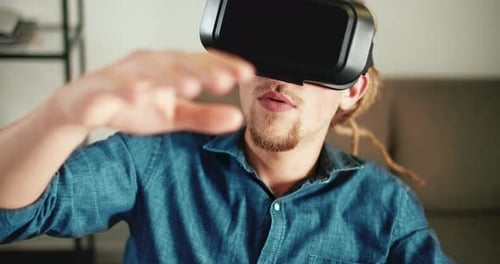 Young Adult Using Virtual Reality Headset Indoors
