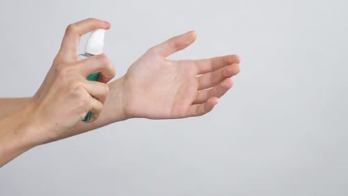 Close-up of Arm with Antibacterial Spray Spreading on Arms with Slow Motion
