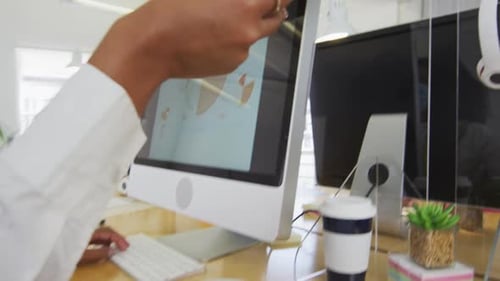 Woman passing a document to her colleague at office