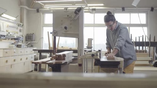 Caucasian Carpenter Smoothing Wood Board on Jointer at Workshop