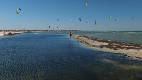 Lots of Colorful Kites Flying in the Sky Over the Sea Kitesurfing Sports