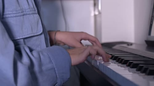 Person Playing Black and White Piano Keyboard