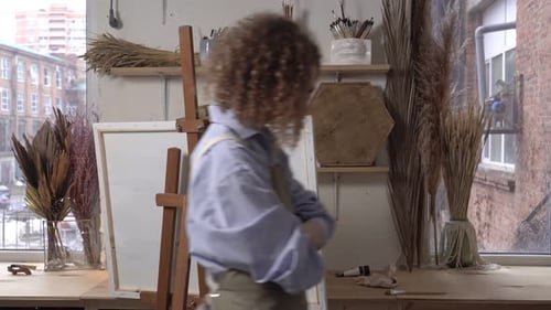 Artist Contemplating Blank Canvas in Studio