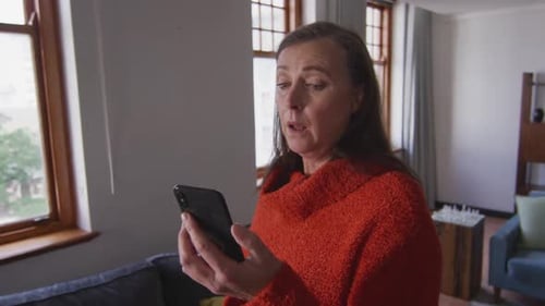 Woman Coughing Into Elbow While Using Cell Phone