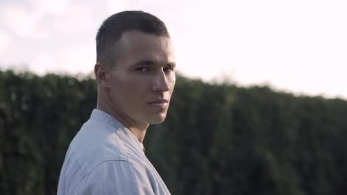 Young guy in the park looking at the camera