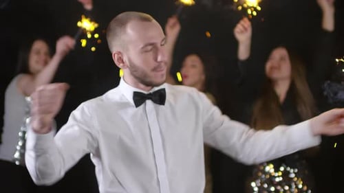 Man with Sparkler Dancing at Party