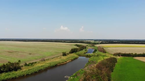 Scenic Aerial View of River Through Rural Farmland