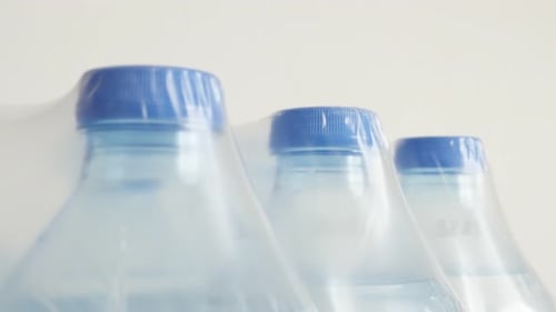 Package of bottled water close-up 4K 2160p 30fps UltraHD tilting footage - Lot of transparent PET co