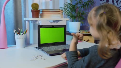 Young Girl Learning with Laptop and Green Screen