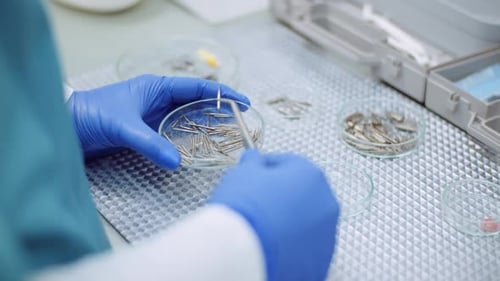 Doctor Sorts Medical Instruments at Healthcare Clinic