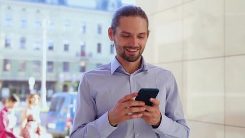 Man Using Mobile Phone, Messaging At City Street