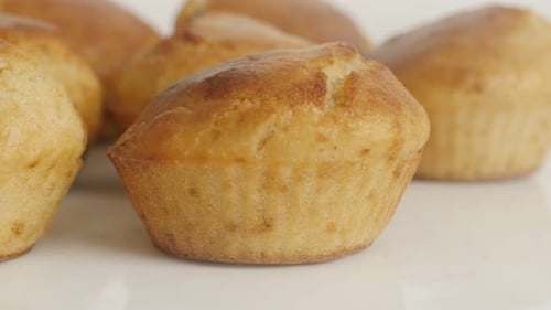 Muffin shaped cornbread slow tilt 4K 2160p 30fps UltraHD footage - Tasty cornmeal on white plate 384