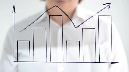 The Businessman Draws the Schedule of Growth by the Marker on Glass