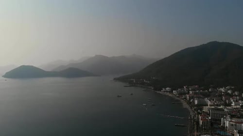 The Camera Flies Along the Coast of the City Beach in the Mediterranean Sea. City Beach with