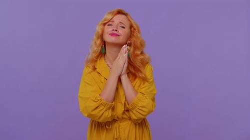 Woman Clasping Hands in Supplication on Purple Background