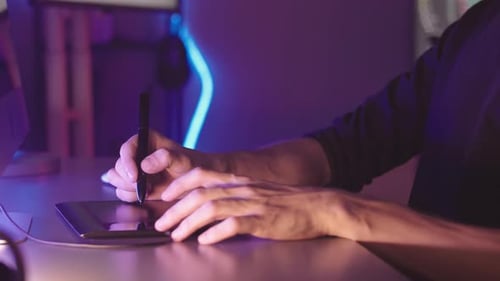 3D Artist Drawing Graphics for Video Game on Tablet