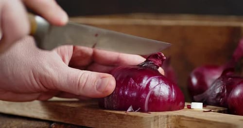 Slicing Red Onion on a Wooden Cutting Board