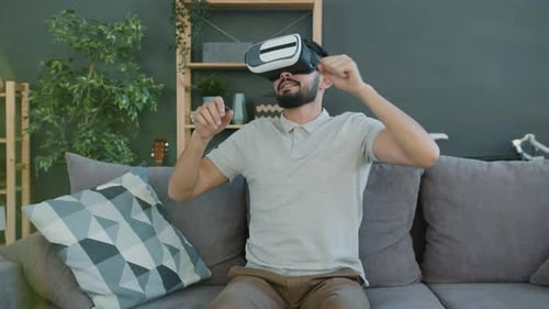 Man Experiencing Virtual Reality on Couch at Home