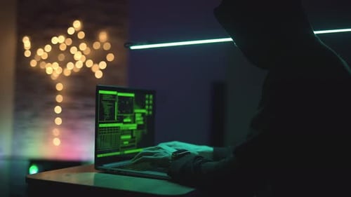 Hacker is Working on Laptop at Night