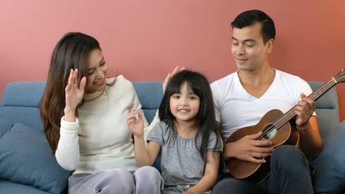 happiness family young female with parent play ukulele together