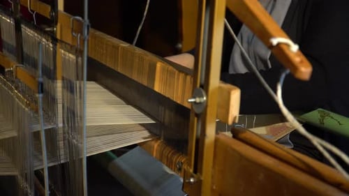 Woman Weaving Fabric on a Traditional Wooden Loom