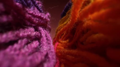 Camera Moves Above Rows of Colored Woolen Threads for Knitting. Wool Texture Close Up. Super Macro