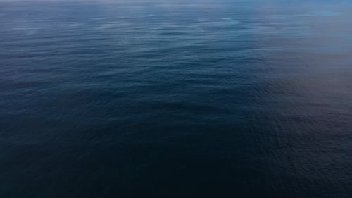 Seascape By Day. Calm Sea and Sky with Clouds. Aerial View Boundless Water Surface Sea. Flying Over